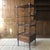 A 19th century Regency four tier etagere with rare lotus carved legs, brass casters, two drawers with brass drawer pulls...