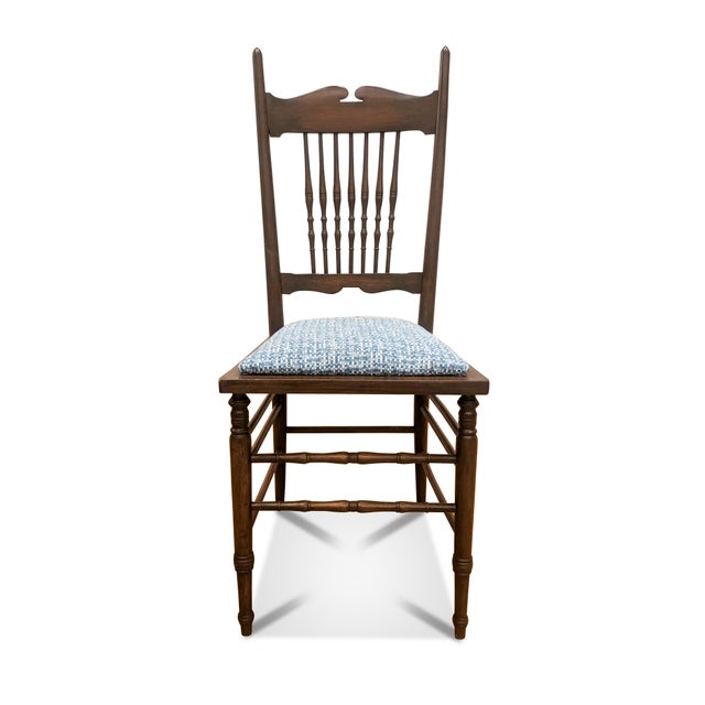 An antique spindle back chair that has a newly upholstered seat cushion. The high back chair (39") features 7 turned...