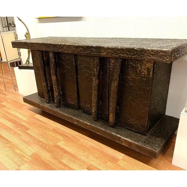 A fabulous vintage hand hammered credenza with plates riveted to a wood frame. There are 4 doors with 4 long handles. Each...