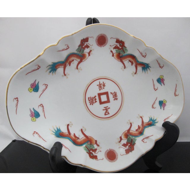 Japanese porcelain serving dish in white porcelain with colorful dragon motif and good fortune symbol with script....