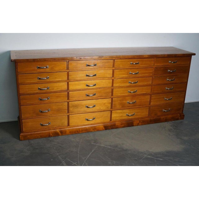 This apothecary cabinet was made circa 1950s in the Netherlands. It features 24 drawers with nice chrome handles. The...
