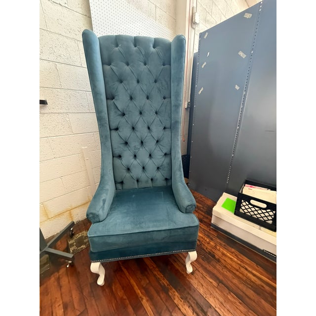 This dramatic , whimsically high backed blue velvet wingback armchair delivers instant statement appeal with its soaring...