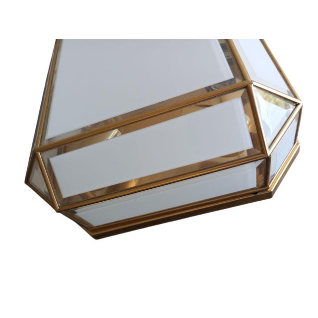 An elegant geometric-style wall sconce dating back to 1970s Italy. The square structure (30 x 30 cm) is 15 cm deep and...