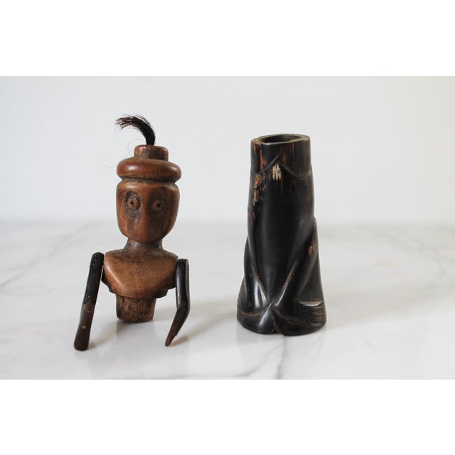 Vintage African folk art sculpture or doll carved from wood and dark horn. The figure features a distinct topknot of hair...