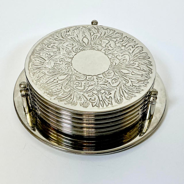 A set of 6 Silver Plated Coasters with a coordinating Caddy. These are from the Mid-Century and have rubber pads on the...
