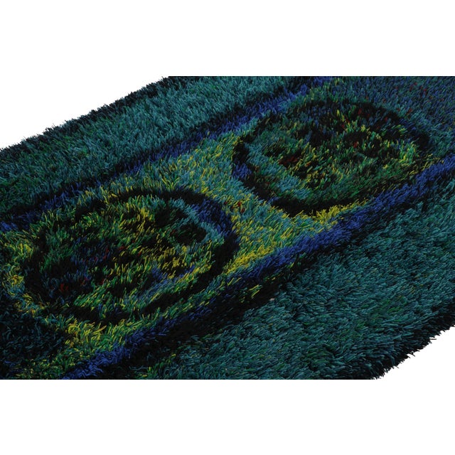 Hand-knotted in lush, high-pile wool in Sweden circa 1960-1970, this 4x6 vintage Swedish rya rug is a bold new addition to...