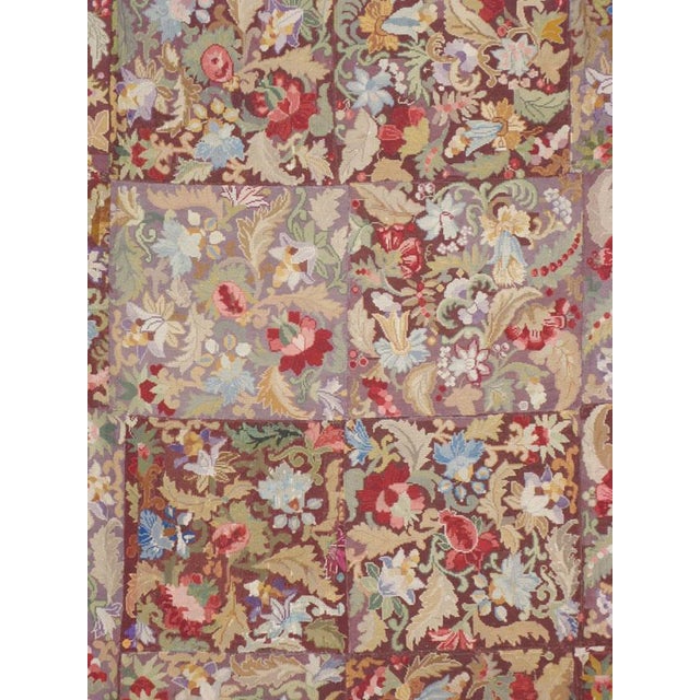 An antique English needlepoint carpet from the first quarter of the 20th century. Measures: 9' 10" x 14' 10"