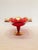 Red glass compote with ornate, hand-painted gold detailing. Tiny, color floral motifs on edges.