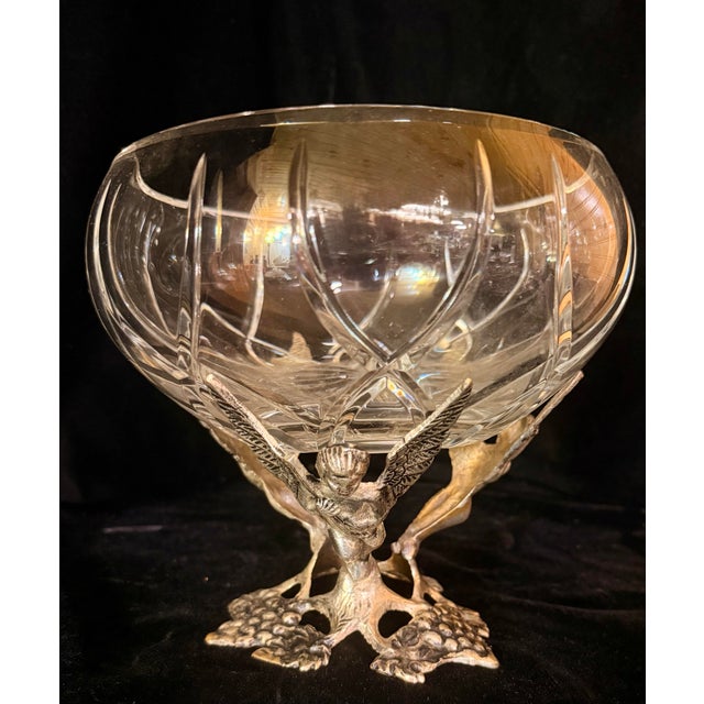 This exquisite antique centerpiece consists of a heavy crystal bowl held by an ornate silver-plated stand. The base...