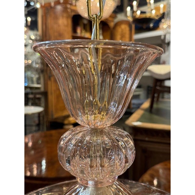 The Petite Pink Murano Glass Pendant with Flowers is a charming and elegant lighting fixture. The intricate design...