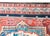 An antique Persian Bakhtiari Saman rug from the 1920s, featuring a striking central floral medallion in red and ivory. The...