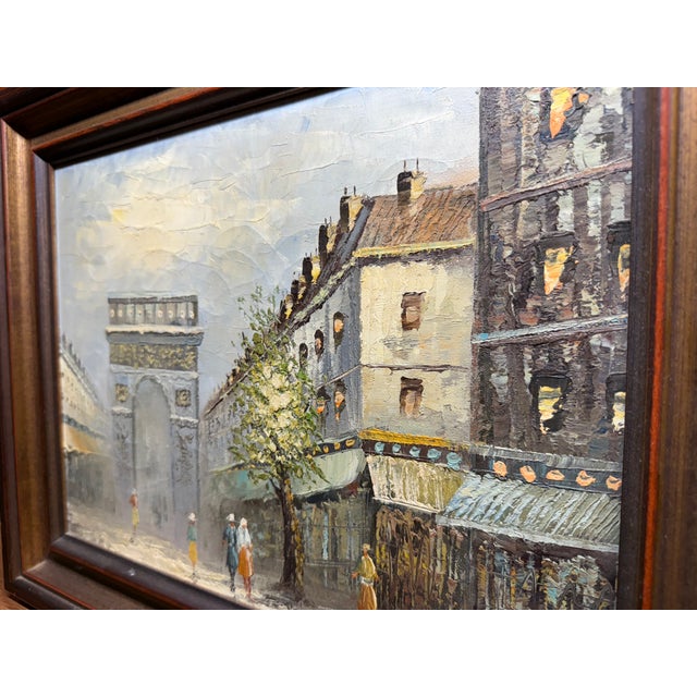 Impressionist oil painting depicting a Paris street scene with the Arc de Triomphe, signed by Caroline C. Burnett.