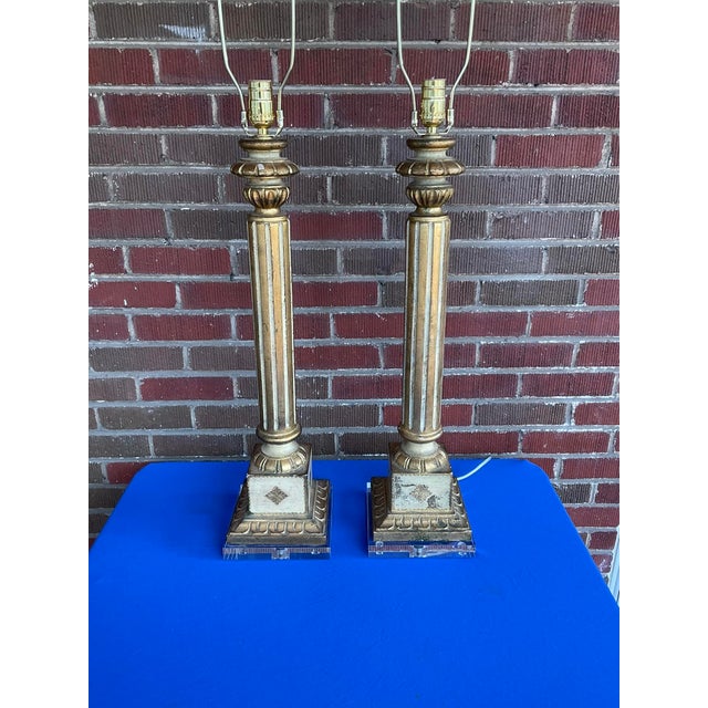 Vintage Italian Florentine Carved Wood Column Lamps w/ Lucite Bases in good estate condition. The lamps are in working...