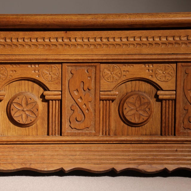 Description for sale is a handcrafted oak chest featuring characterful wood carvings, dating back approximately 50 years....