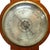 An antique English banjo barometer, dating to the late Victorian period, circa 1880. This scientific instrument is...