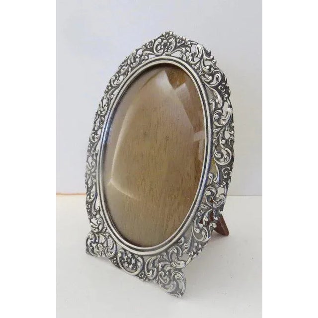 Beautiful work on this oval picture frame. Hallmarked. Easel back. Very good condition.