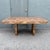 Striking vintage Postmodern dining table featuring a richly figured burlwood laminate finish in warm caramel, honey, and...