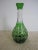 A beautiful vibrant early 20th Century emerald green bohemian cut-to-clear crystal liquor decanter in the style of Val St....