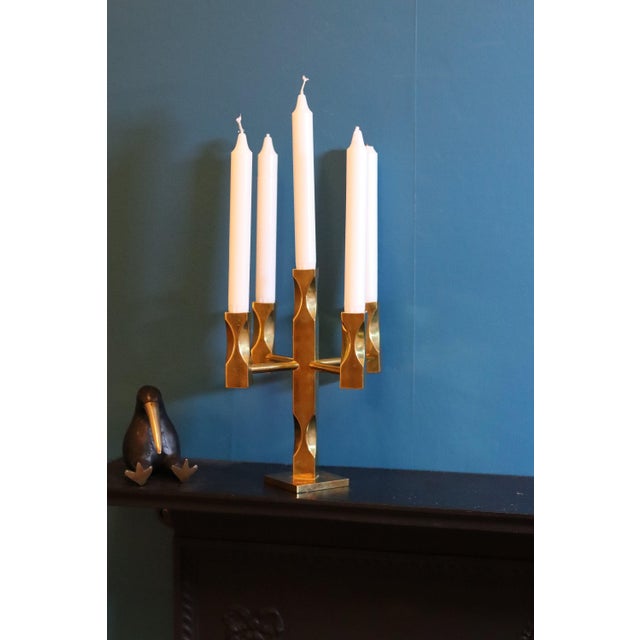 Made in Sweden. A stunning five-arm solid brass candelabra designed by Lars Åkesson for Vallonmässing, Sweden. This piece...
