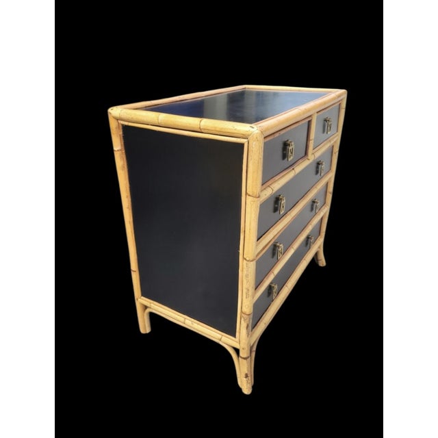 A wonderful vintage smooth black and bamboo surround 5 drawer Regency chest. The chest features smooth black background...