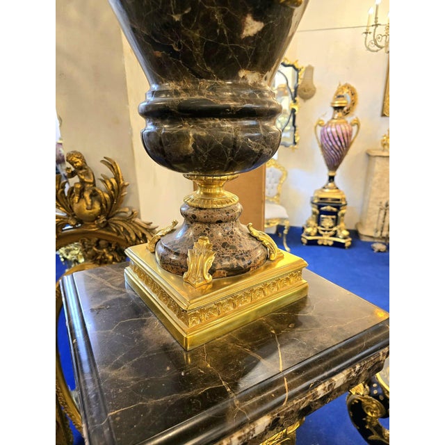 An impressive Louis XVI-style decorative centerpiece featuring shaped porcelain bodies hand-painted with finely detailed...