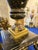 An impressive Louis XVI-style decorative centerpiece featuring shaped porcelain bodies hand-painted with finely detailed...