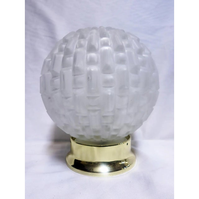 This unique and exquisite French Art Deco sculptural glass globe features a high relief geometric pattern with symmetrical...