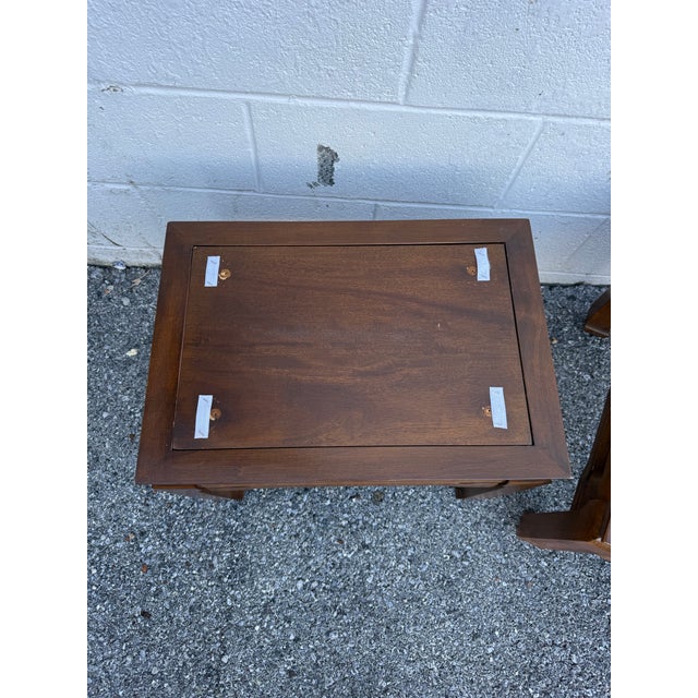 A stylish pair of vintage Asian-style wooden stools or end tables, dating to circa 1970s–1980s. Each piece features a...