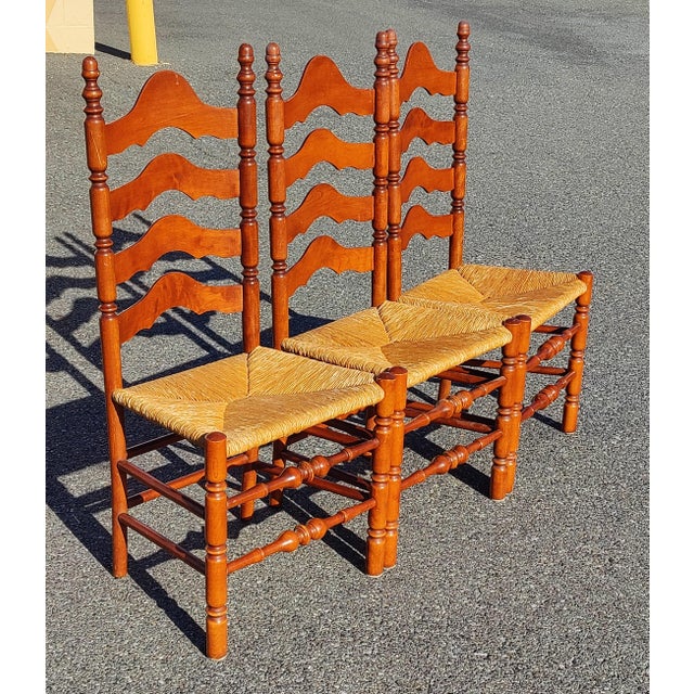 This is a stunning full set of Three vintage Ethan Allen Ladderback rush seat chairs. Solid and sturdy, with minor...