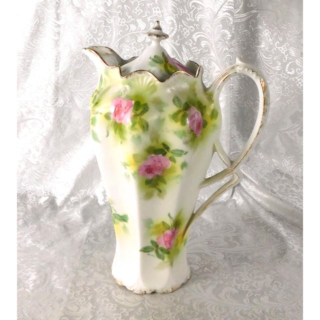 This is a Reinhold Schlegelmilch RS Prussia choocolate pot with six matching cups and saucers. The set is white with pink...
