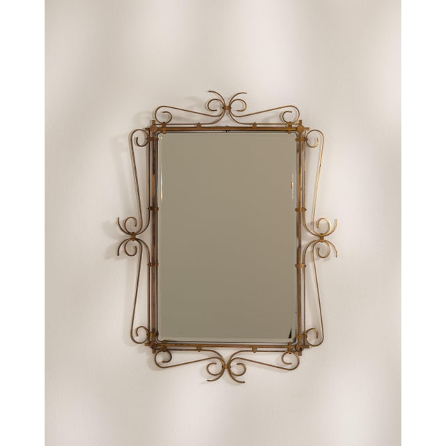A second Art Deco mirror featuring a more rectilinear silhouette, emphasizing balance and proportion. The brass frame adds...
