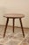 Antique wooden side table, circular in shape, resting on three spirally turned legs that fit into the tabletop, attesting...