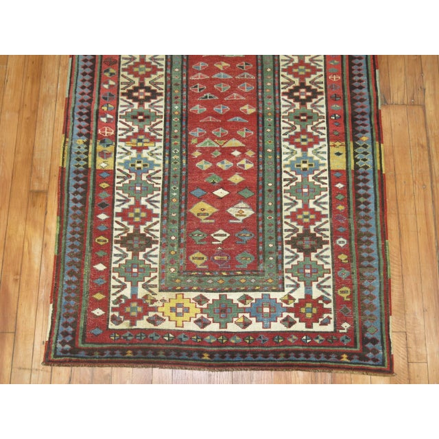 Lovely Caucasian Talish runner from the late 19th century in earth red, blue ivory red and yellow accents. The colorful...