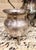 An ornate five-piece tea and coffee service by English Silver Mfg. Corp. The set includes a lidded coffee pot, lidded...