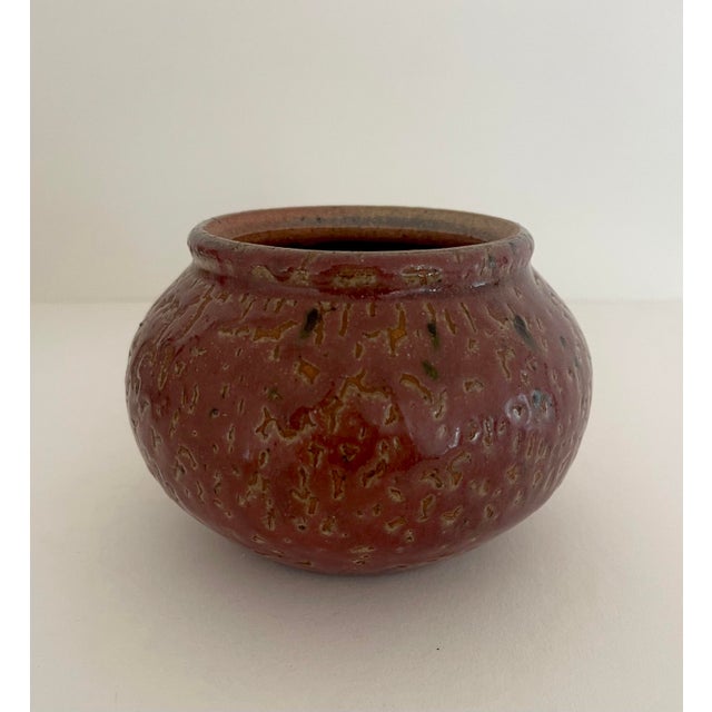 Beautiful handcrafted vase with mauve colored glaze. Artist signed and dated.