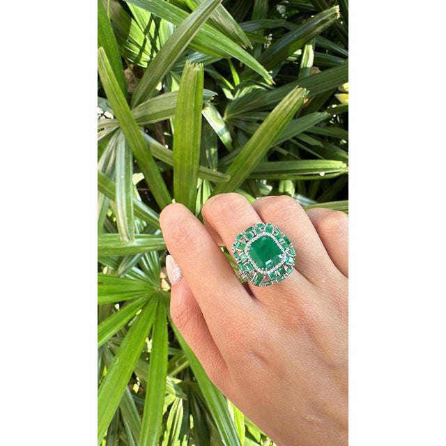 A very gorgeous and beautiful, modern style, Emerald Engagement Ring set in 18K White Gold & natural Diamonds. The...