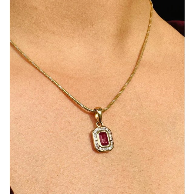 This is part of Chairish’s Fine Jewelry assortment. Art Deco Octagon ut Ruby and Diamond Halo Pendant in 14K Gold studded...
