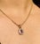This is part of Chairish’s Fine Jewelry assortment. Art Deco Octagon ut Ruby and Diamond Halo Pendant in 14K Gold studded...