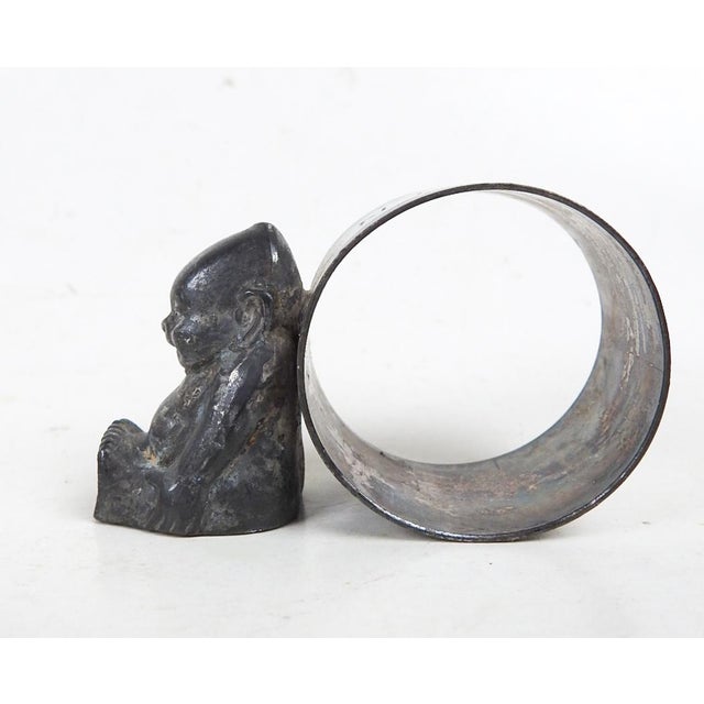 Antique early 20th century silverplate Billiken figural napkin ring with Billiken engraved on ring. Unmarked, overall dark...