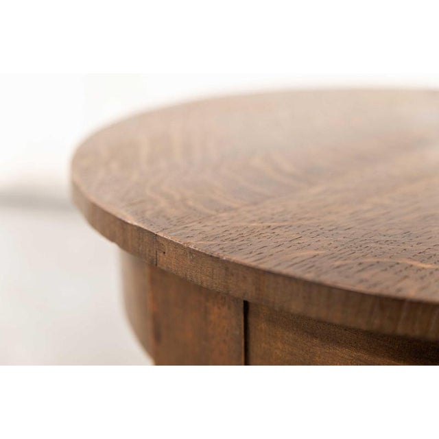 Art deco side table, designed and produced in the Netherlands in the 1950’s. The simple round top was combined with cross...