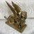 Bronze lion representing the Lion of Saint Mark, the winged symbol of Venice, holding a book, the Gospel, open under its...