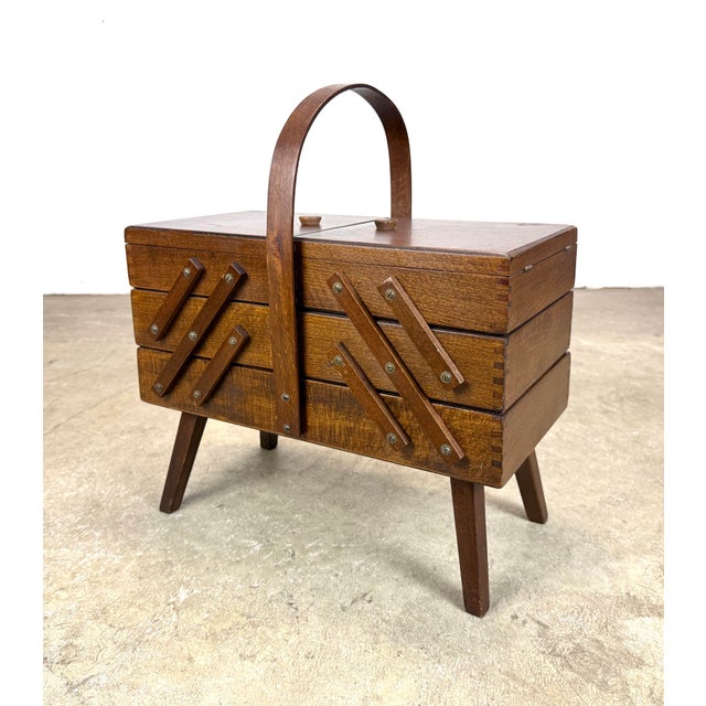 A super functional small mid century modern accordion sewing caddy made in Romania circa 1960s. Velvet lined compartments....