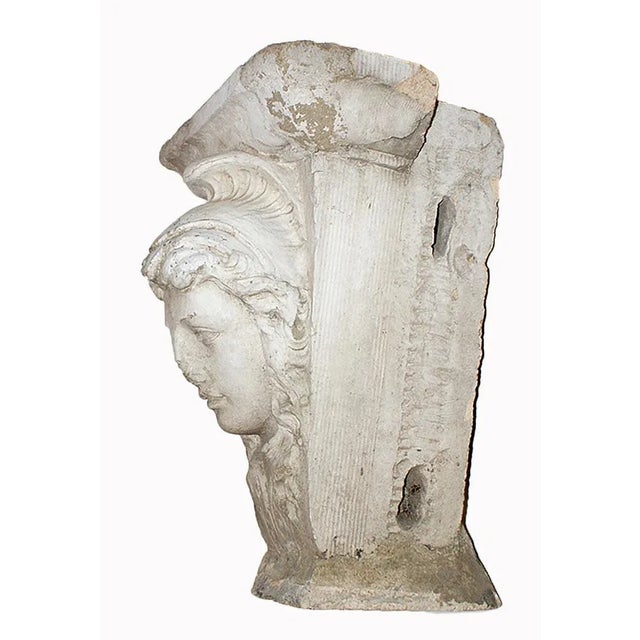 Traditional antique terra cotta pedestal with the face of Athena. Late 19th century.