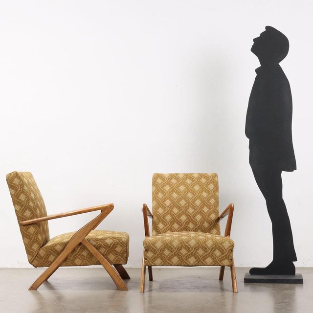 Pair of 20th century Italian-made armchairs with wooden armrests and feet, spring padding and original textured velvet...