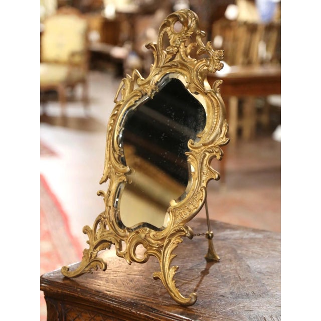 Graceful curves and finely cast ornament distinguish this antique freestanding vanity mirror. Crafted in France circa...