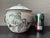 An authentic early 20th Century Chinese porcelain lidded warming pot featuring a hand-painted Famille Rose scene of...