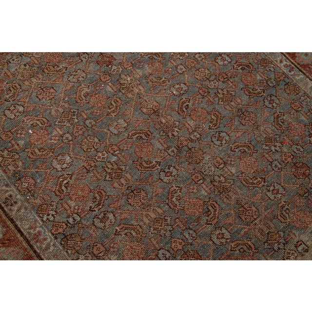 Beautiful antique Malayer hand-knotted wool rug with a blue color field. This Persian rug has rust accents in a gorgeous...