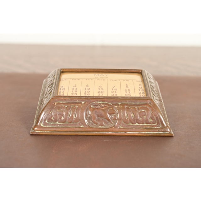 A gorgeous antique Arts & Crafts or Art Deco bronze desk calendar holder or picture frame featuring Zodiac designs By...