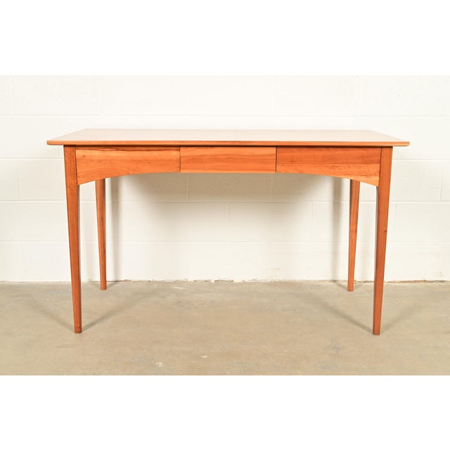A gorgeous minimalist Arts and Crafts or Shaker style solid cherry wood writing desk By Harden Furniture USA, Circa Late...