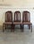 This set of 6 dining chairs features tall slatted backrests with geometric arched frames. Crafted with dark stained wood...